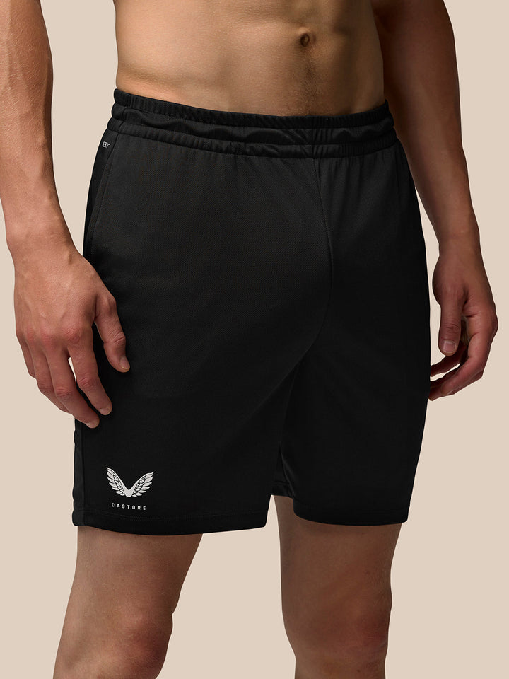 Male model wearing black Adapt Training 7 inch shorts with drawcord waistband and side pockets.