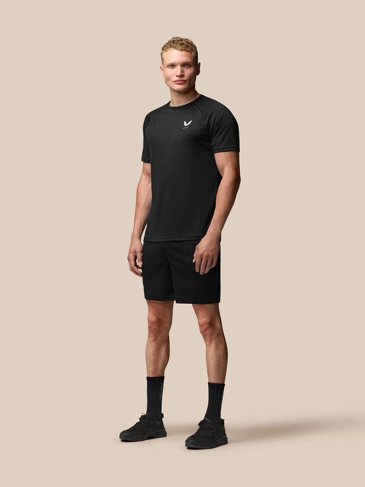 Male model wearing black Adapt Training 7 inch shorts with side pockets and Castore logo on the right thigh