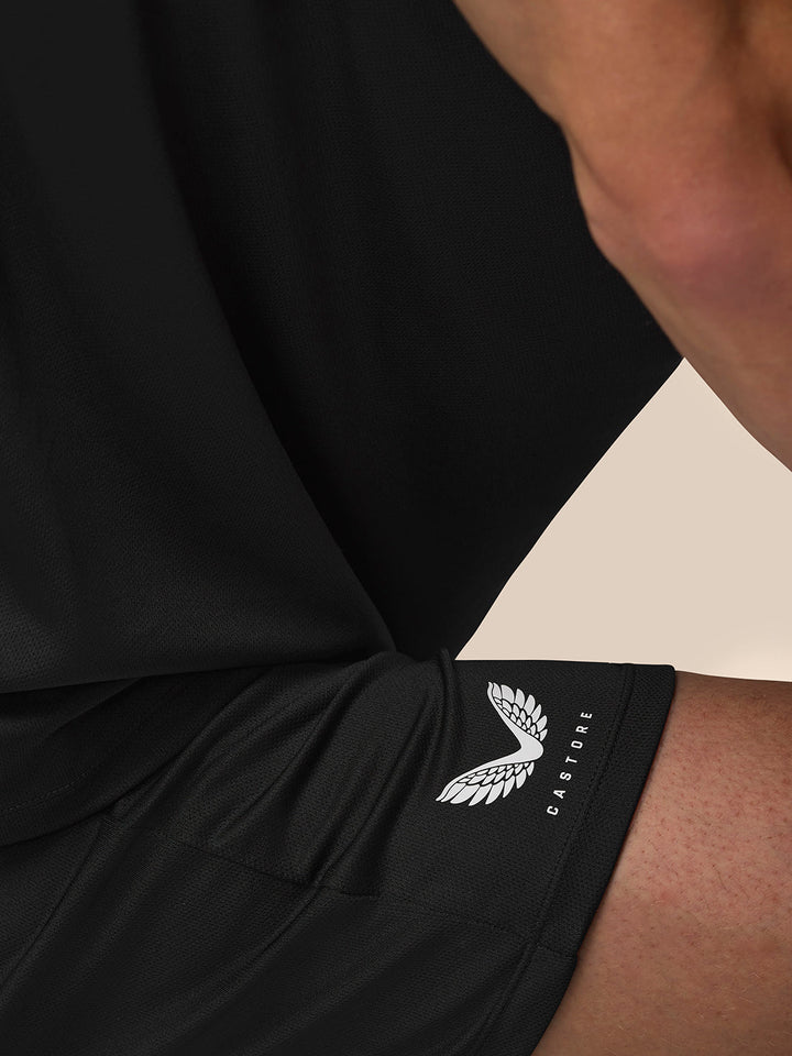 Close-up of black athletic sleeve cuff with white Castore wing logo