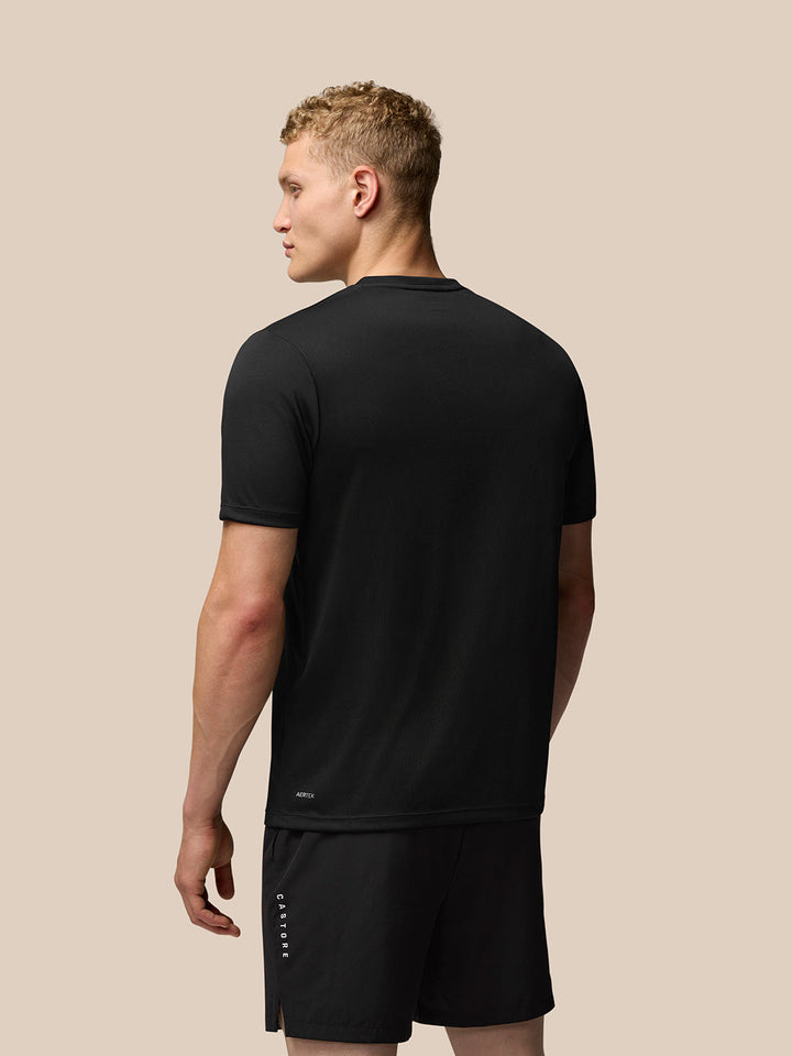 Rear view of a man in a black Adapt Training T-Shirt showing Aertek branding at the back hem
