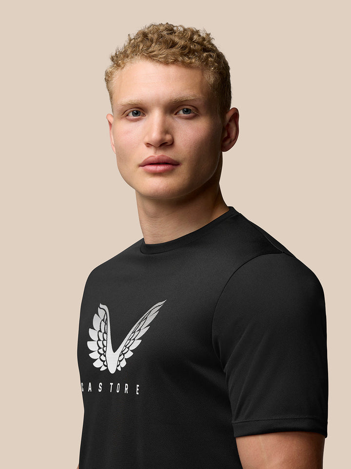 Front view of a man wearing the black Adapt Training T Shirt with Castore wings graphic on the chest