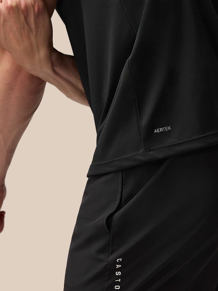 Close up of black Adapt Training T Shirt fabric with AERTEK branding at the lower back seam