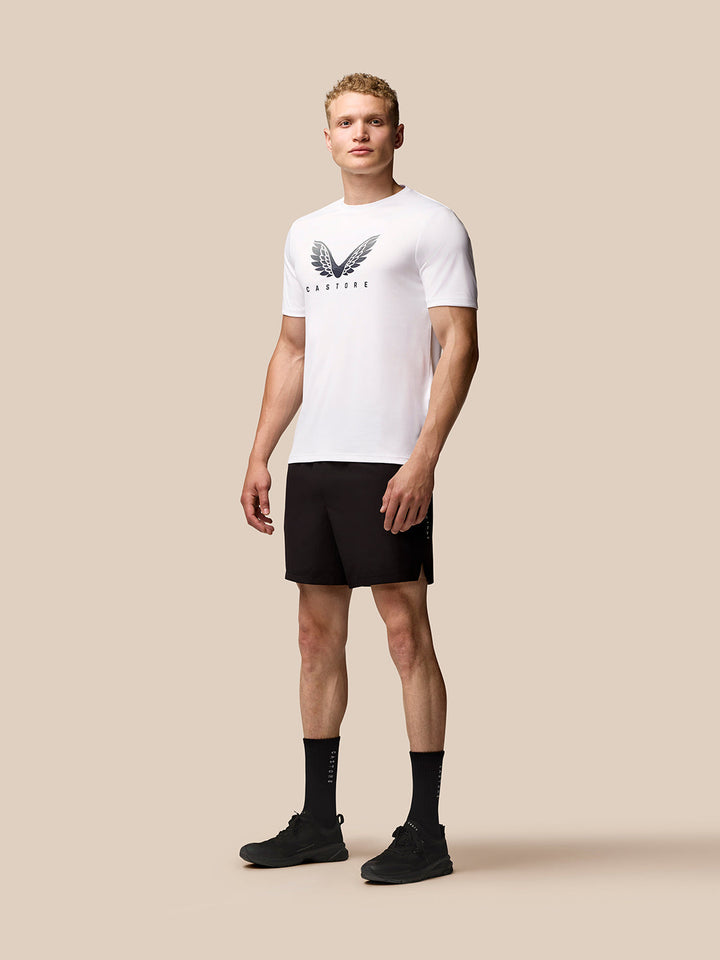 Man wearing white Adapt Training T-Shirt with Castore wings logo on chest and black shorts