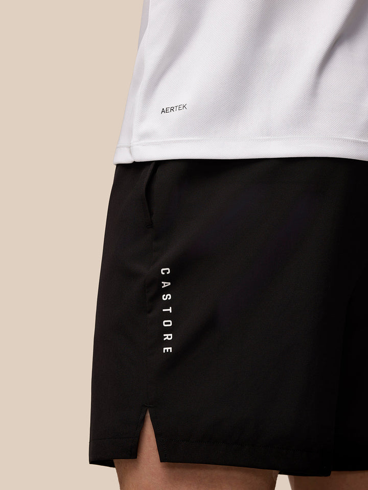 Hem area of white Adapt Training T-Shirt showing AERTEK branding with black shorts featuring CASTORE vertical text