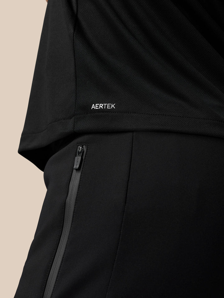 Close-up of black Graphic Training T-Shirt showing AERTEK branding on the back hem