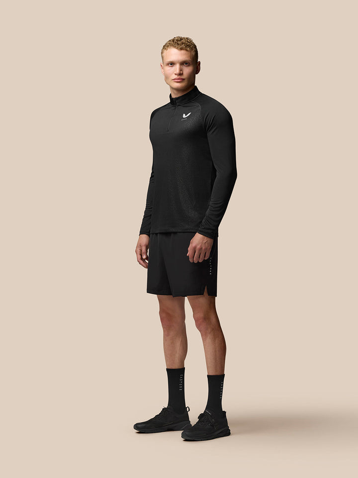 Male model wearing black Adapt Print Quarter Zip Top with stand collar and allover geometric pattern