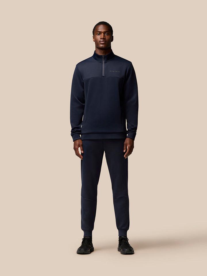 Male model wearing navy Flex Lifestyle Joggers with a matching zip top, front view.