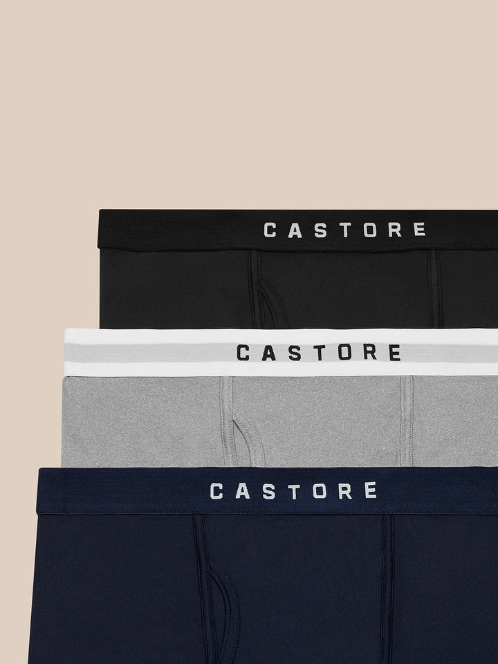 Three-pack of Castore boxer shorts in black gray and navy with branded waistbands stacked