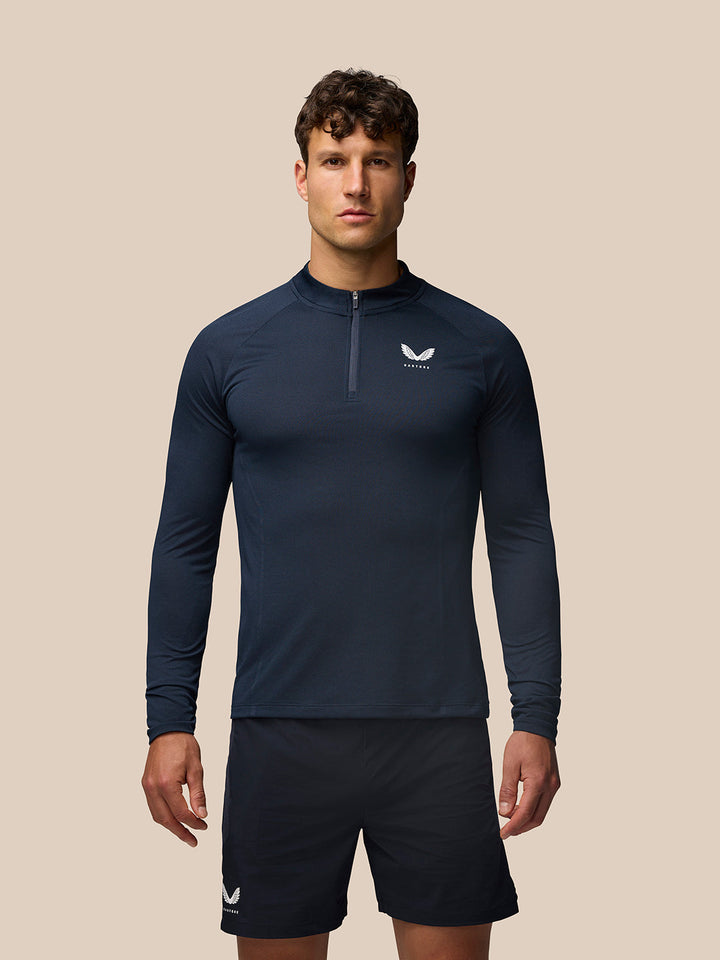 Male model wearing Apex Training Quarter Zip Top in Midnight Navy with Castore branding on the chest