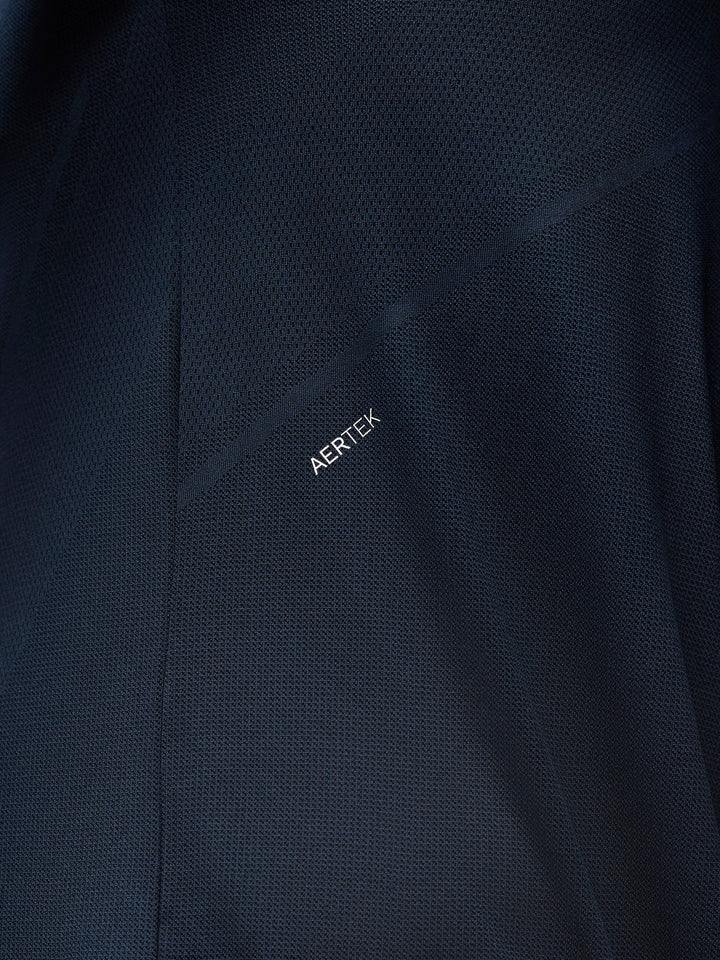 Close-up of navy Apex knit fabric with diagonal seam and AERTEK branding