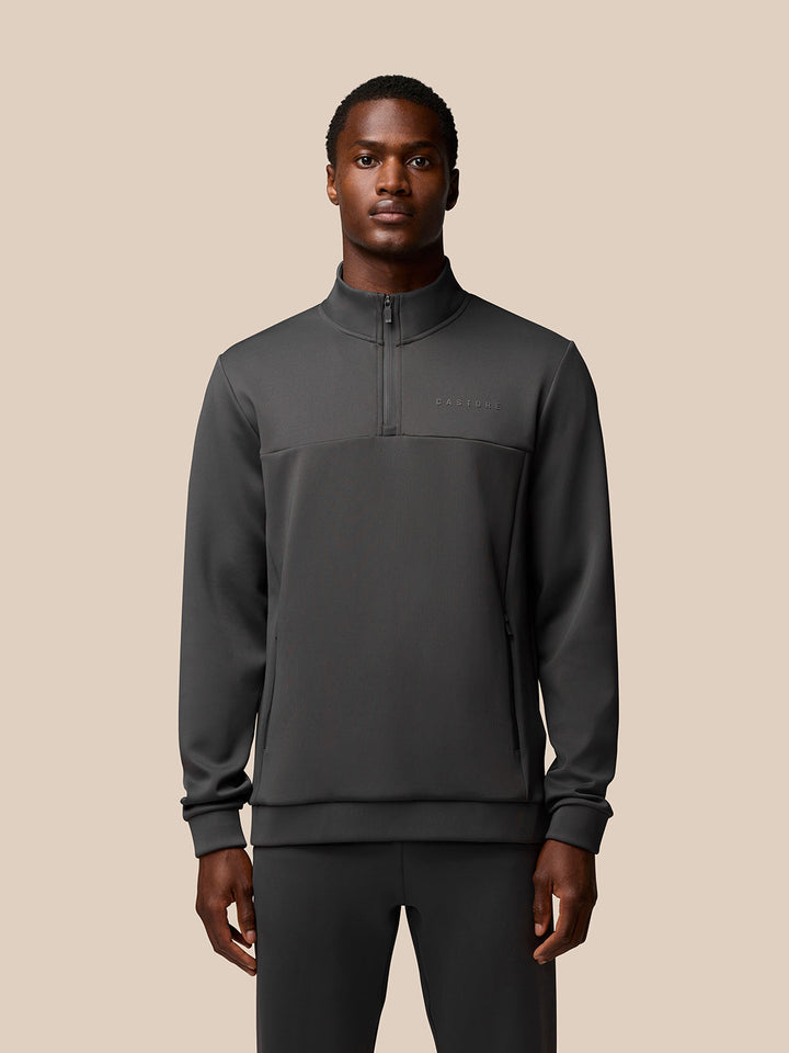 Front view of a man wearing charcoal Flex Sweatshirt with a quarter-zip collar and zip pockets.