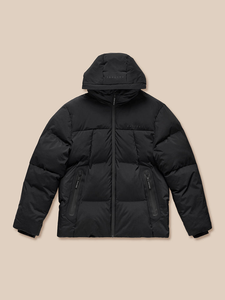 Black hooded puffer jacket laid flat with front zip and side pockets and Castore branding on chest.