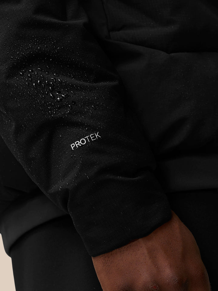 Close up of black jacket sleeve with water droplets and PROTEK branding