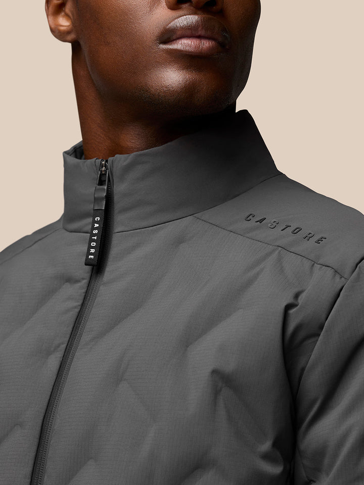 Close-up of zipper and collar area on Charcoal Quilts Lifestyle Jacket with CASTORE branding on pull