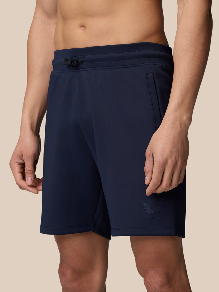 Male model in navy zip-neck top and joggers, full body front view.