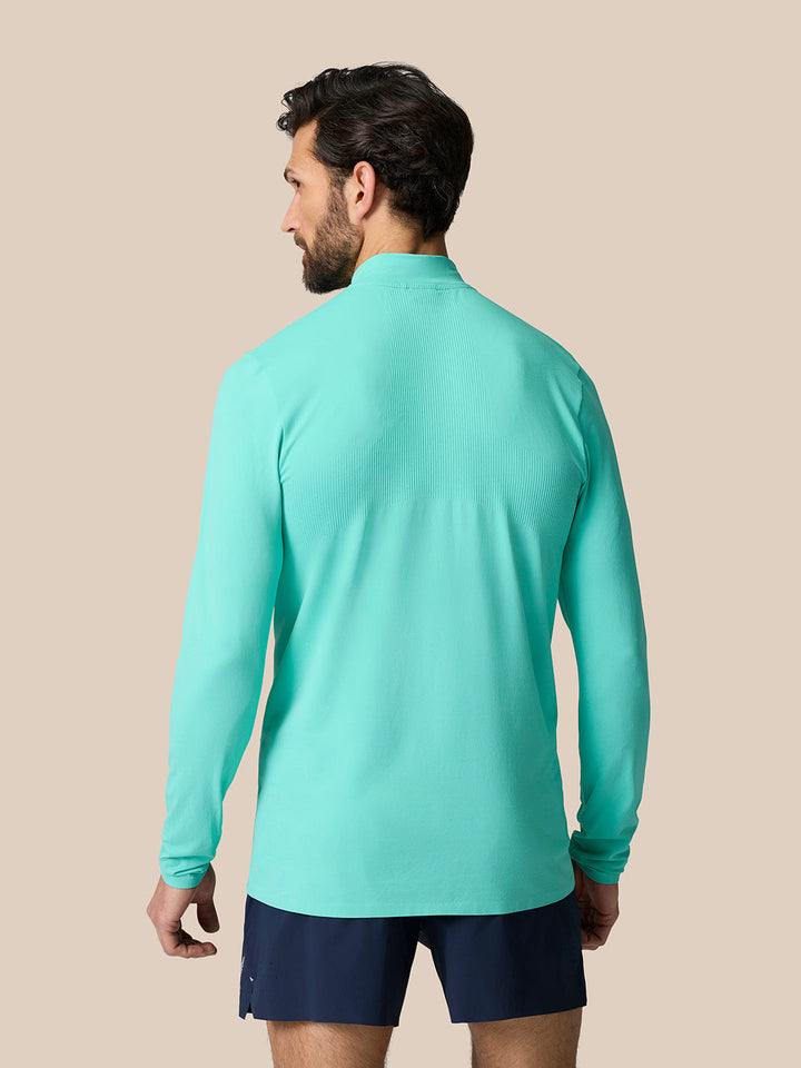 Back view of Zone Training 1/4 Zip Top in mint aqua on a model showing back ribbing and relaxed fit