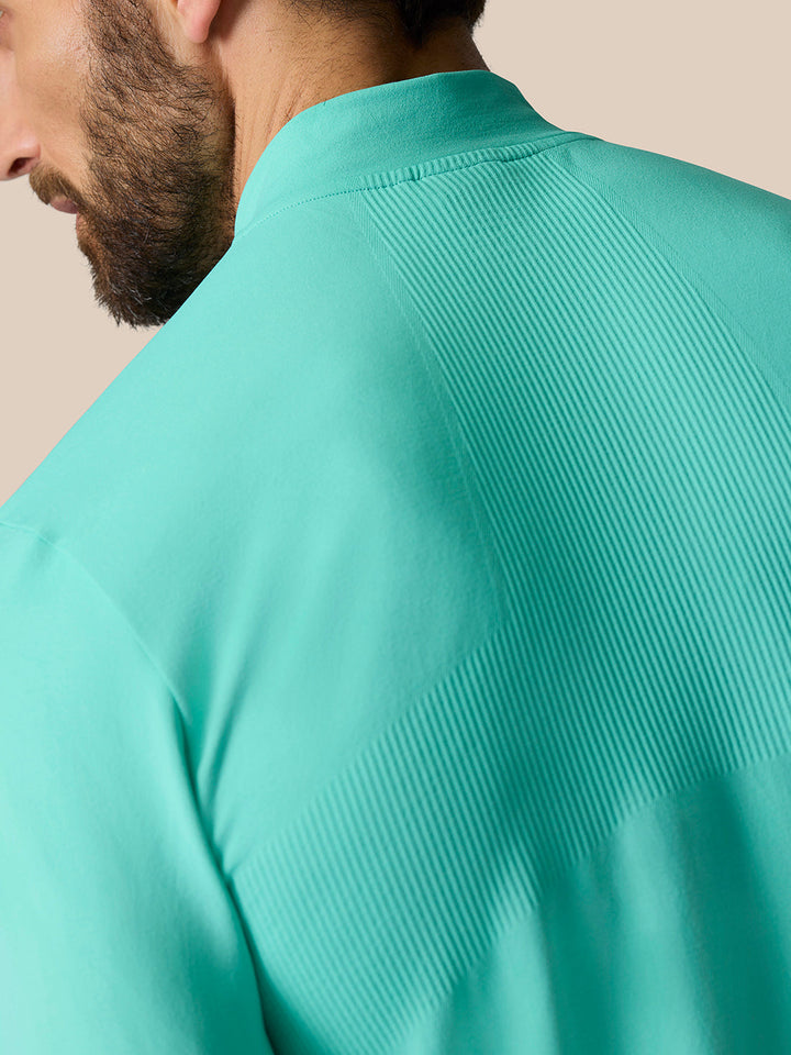 Close up of back shoulder with ribbed ventilation panel on the light aqua Zone Training quarter zip top.