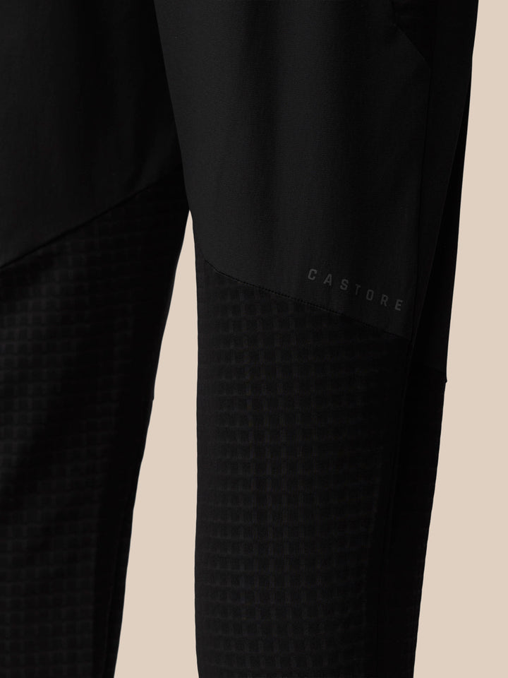 Close-up of Flex Winterised Woven Joggers leg with Castore branding and subtle grid texture.