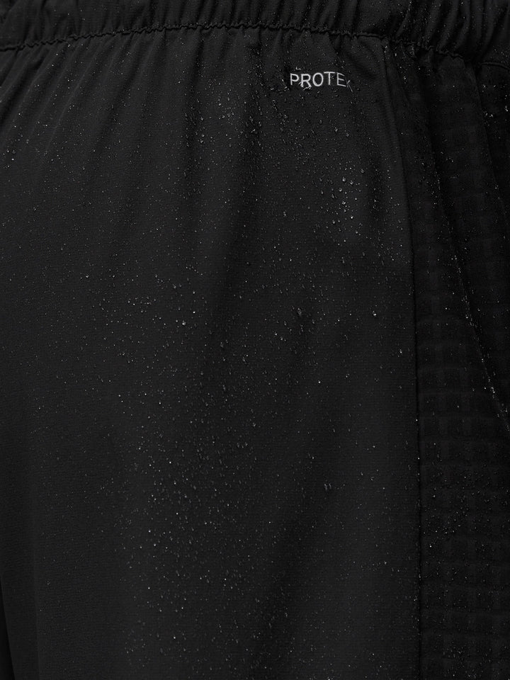 Close-up of Flex Winterised Woven Joggers fabric with ProTek water resistance and droplets.