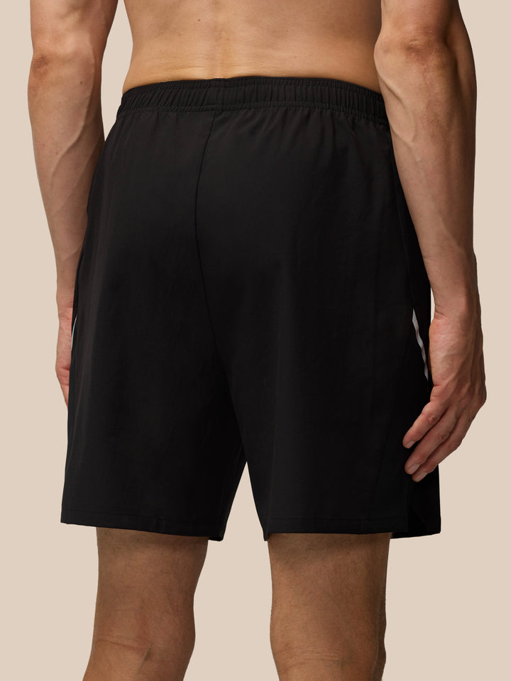 Black Apex 6-Inch Shorts shown with waistband and Castore logo on the lower leg with a side slit