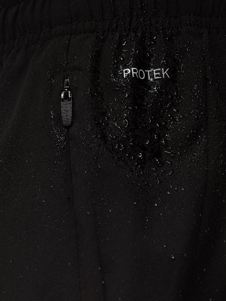 Close-up of black Apex shorts showing ProTek zipper detail and Castore logo on the leg