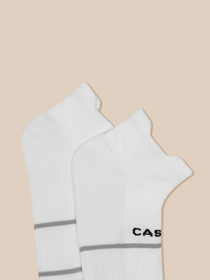 White active training socks with gray cuff stripes and Castore logo, part of a 3-pack.