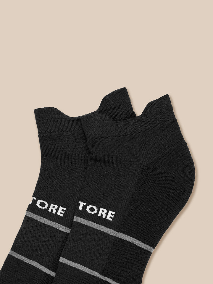 Close up of another black athletic sock showing the CASTORE branding and gray bands near the toe area