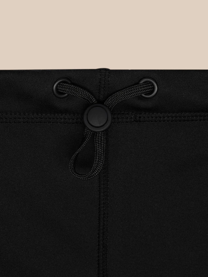 Back view of the black Active Snood showing drawstring and toggle.