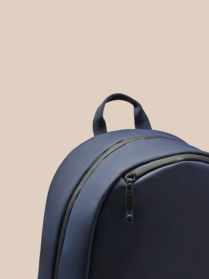 Back view showing padded back and mesh shoulder straps of the navy Active Small Backpack