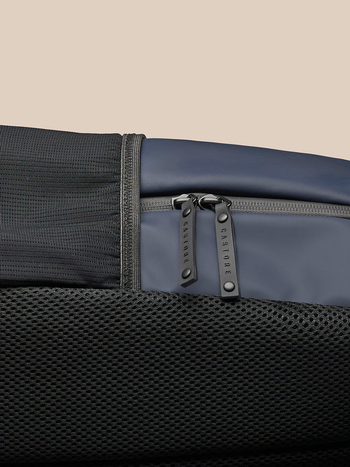 Close-up of zipper area with dual pulls on the navy Active Small Backpack mesh panel