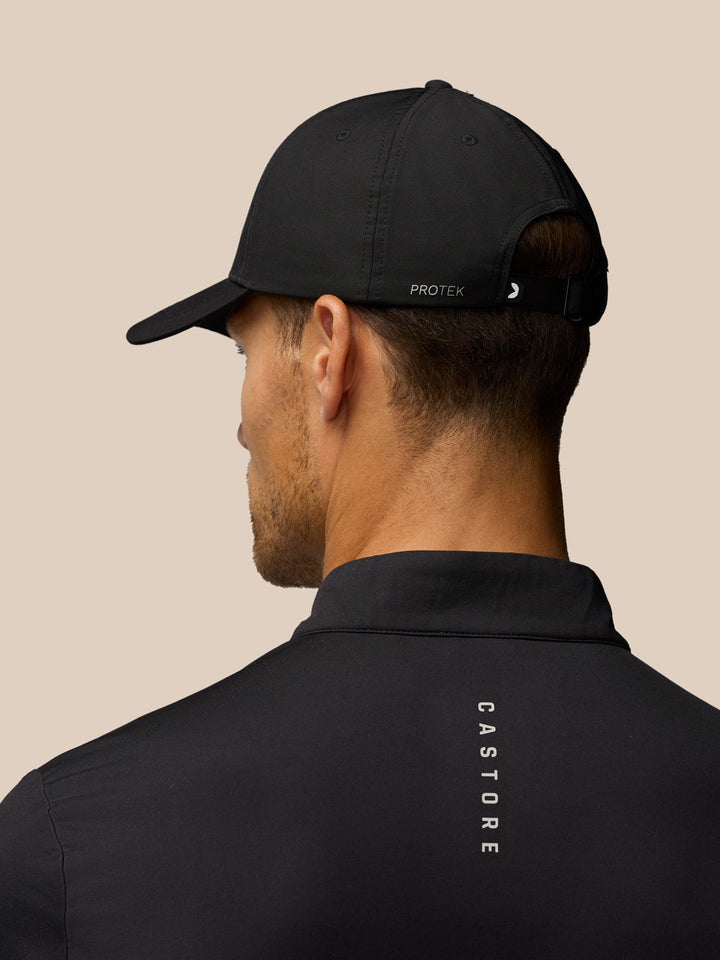 Back view of black nylon cap with halo eyelets and adjustable back strap; protek branding visible.