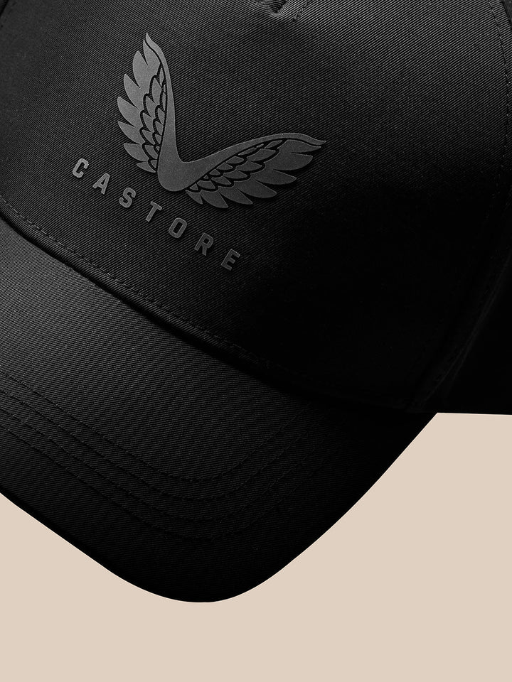 Close up of winged Castore logo on black cap with textured fabric