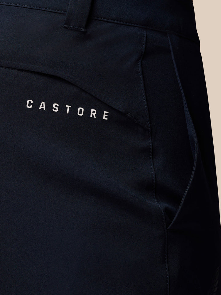 Close-up of navy golf trousers back pocket with Castore branding.