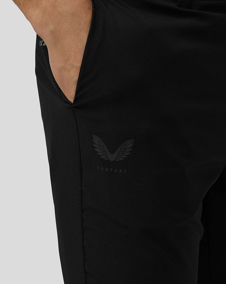 Close-up of black golf shorts with Castore logo on the thigh and a visible side pocket.