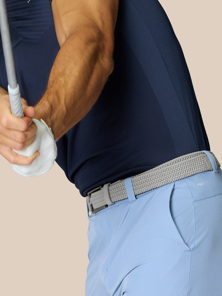 Back view of light blue golf shorts with braided belt and ProTek branding on the rear pocket