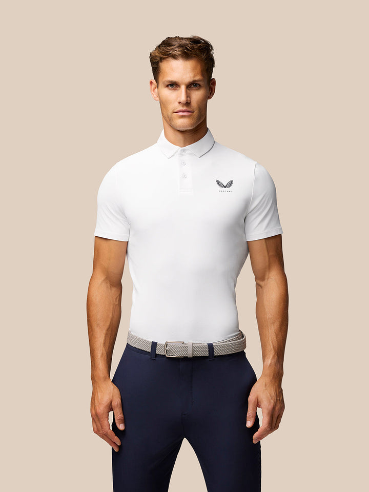Front view of a man in a white Golf Club Essential Polo with Castore logo on the left chest and a three button placket