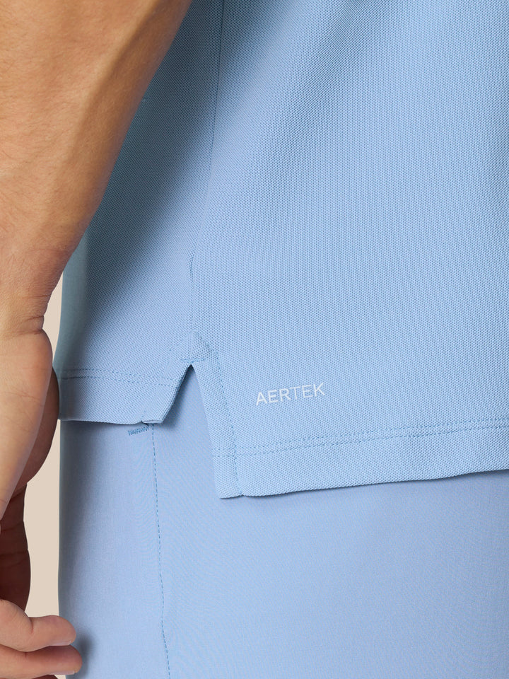 Close-up of light blue golf polo fabric with AERTEK label near the hem