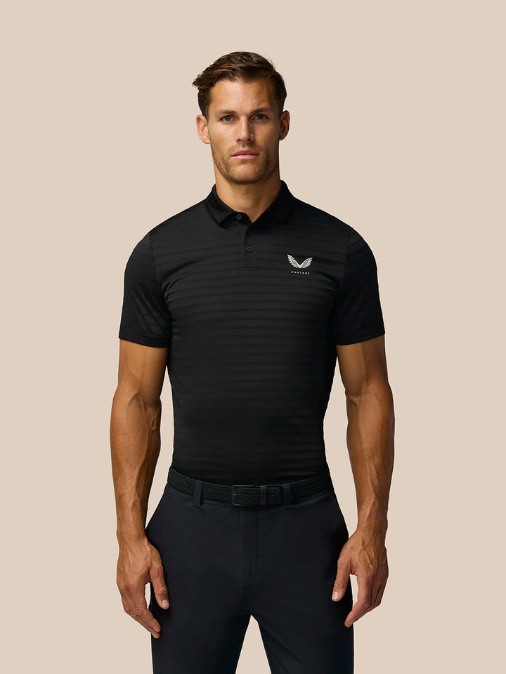 Man wearing black Golf Pinnacle Pique Stripe Polo with subtle horizontal stripes and Castore branding on upper back