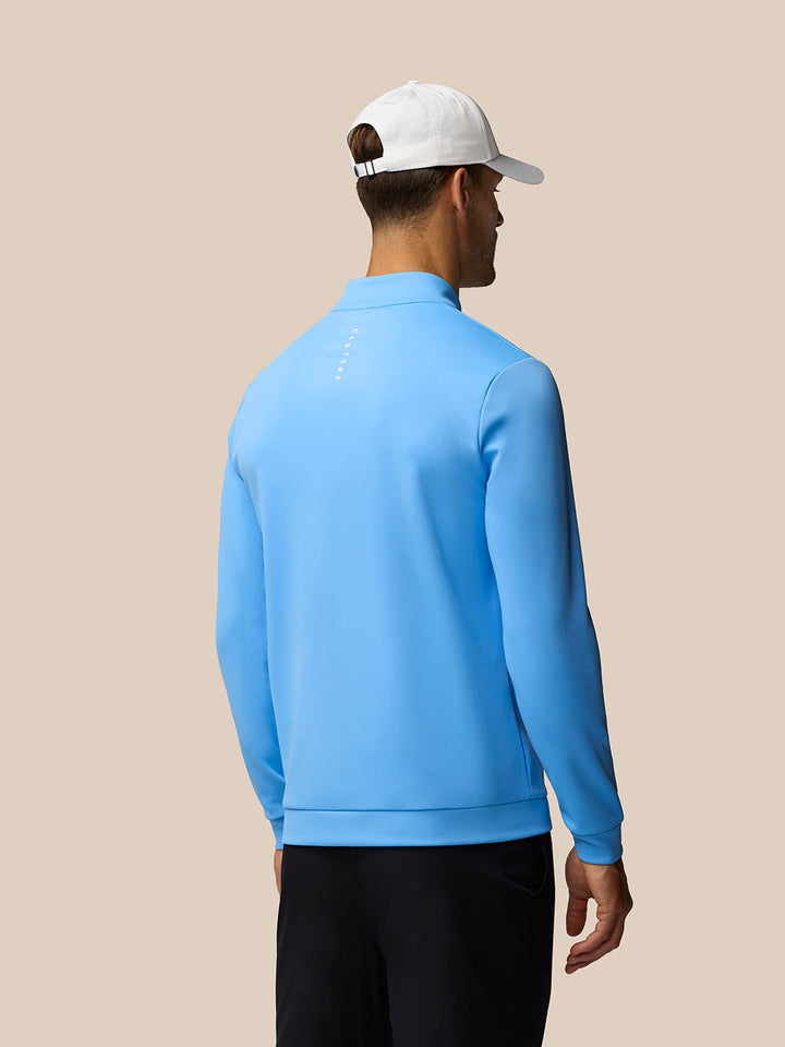Back view of a light blue Golf Club Classic 1/4 Zip Top on a model with vertical Castore branding along the back
