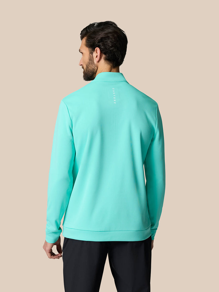 Back view of man in light aqua Golf Club Classic Quarter Zip Top showing Castore branding on the upper back
