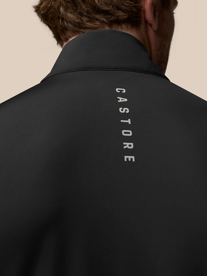 Back view of black Castore Golf Pinnacle Gilet with CASTORE lettering running down the center back