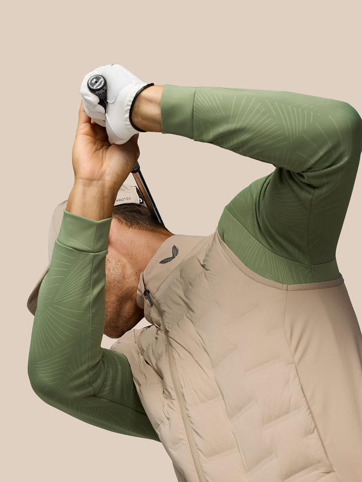 Model in mushroom golf gilet with front zipper and quilted panels, Castore logo at the collar and green sleeves