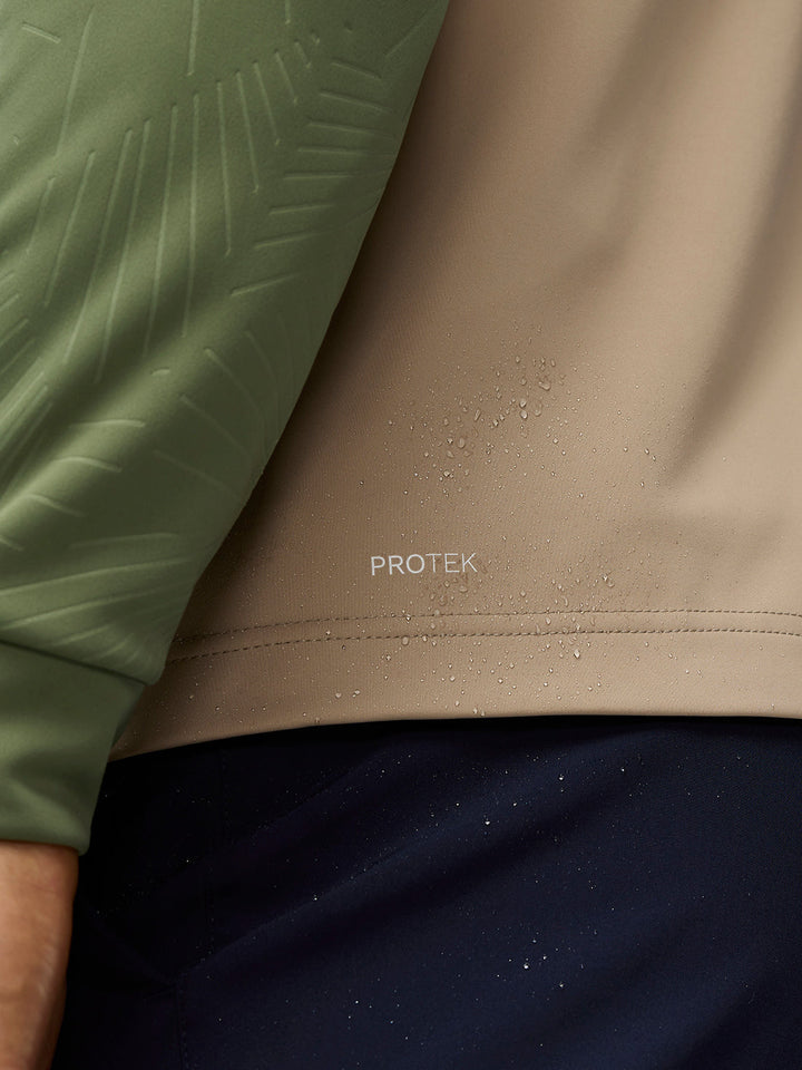Close-up of beige golf gilet fabric with ProTek water-repellent finish and droplets