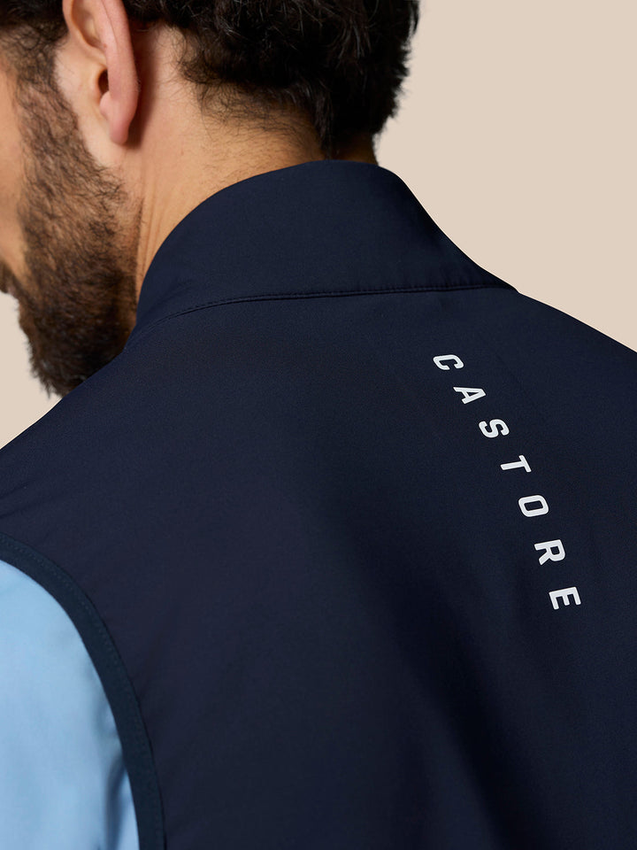 Close-up of navy Pinnacle gilet collar with Castore branding along the upper back.