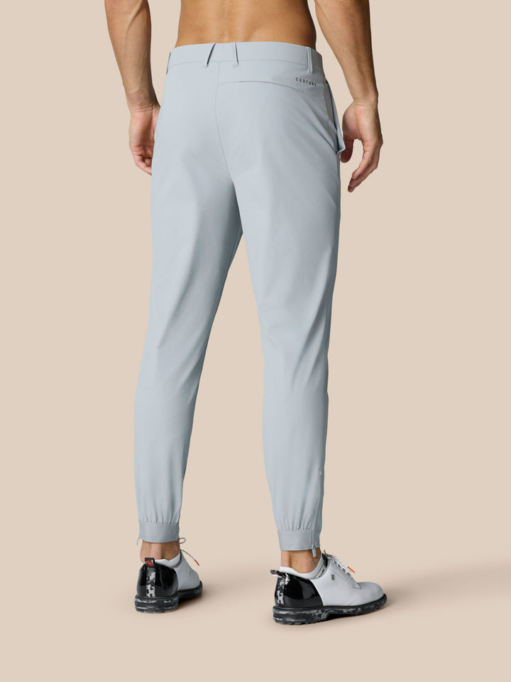 Back view of light grey Golf Pinnacle 32 trousers with zip ankle cuffs and Castore branding at the rear