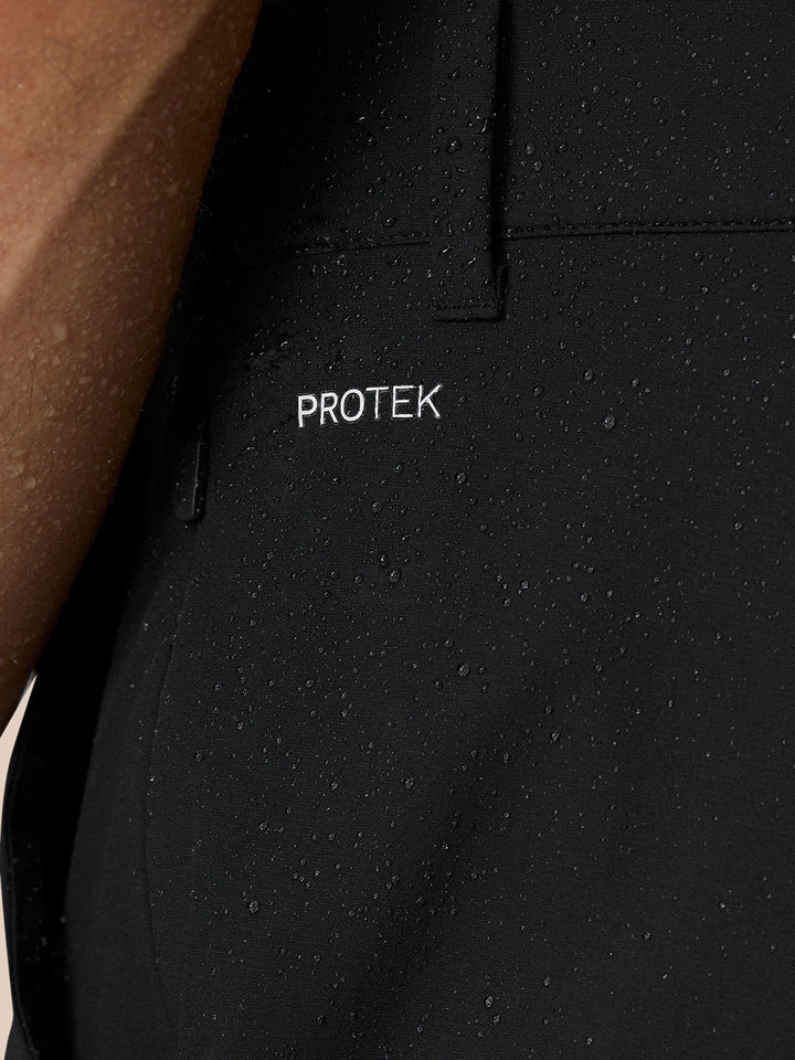 Detail shot of ankle zip and cuff on black Golf Pinnacle 32 trousers, shown with a white trainer.