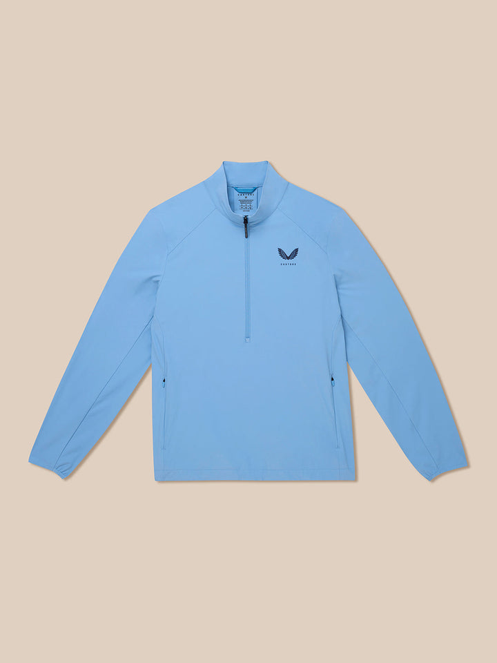 Front view of sky blue Golf Flex Jacket showing half zip front and Castore logo on left chest.