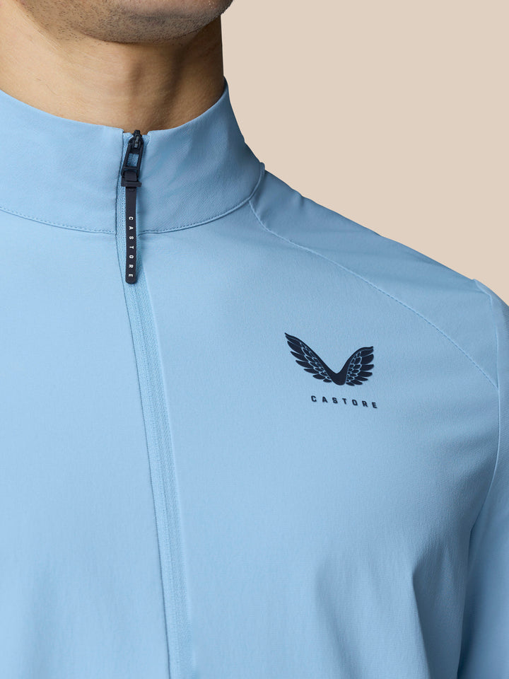 Close up of sky blue Golf Flex Jacket chest area with front zip and Castore logo