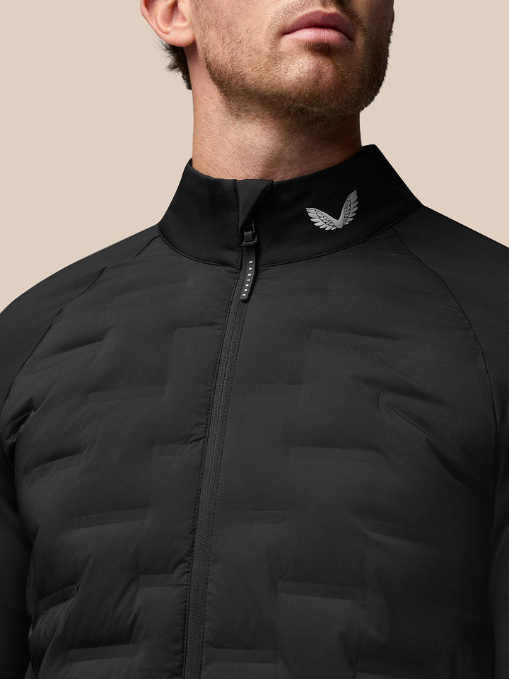 Close up of zip and stand collar with winged emblem on black Golf Pinnacle Jacket