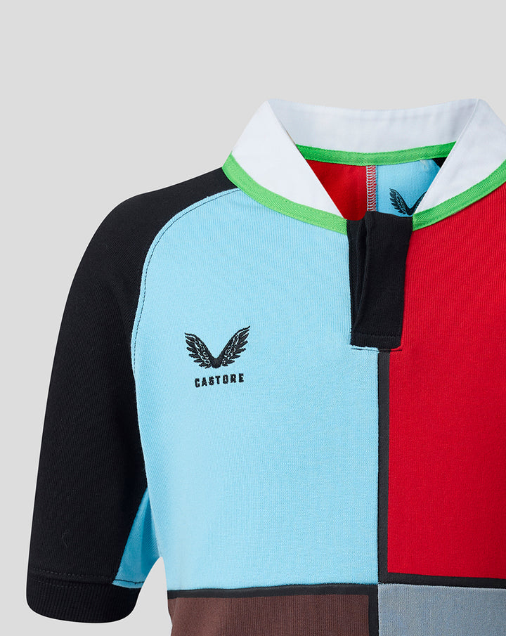 Close up of shoulder area showing light blue and red panels with green neck trim and Castore branding.